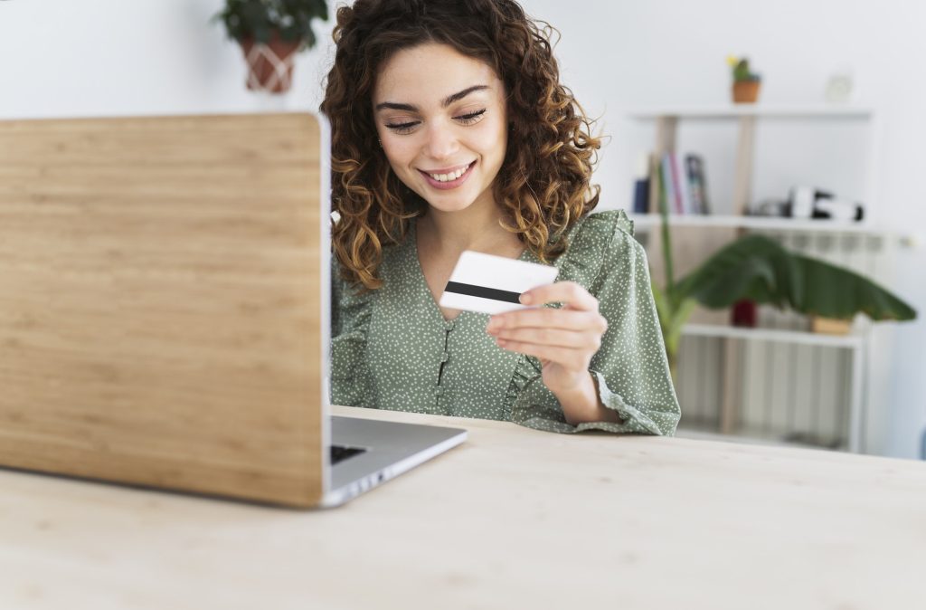 beautiful curly-haired woman buys with a credit card online