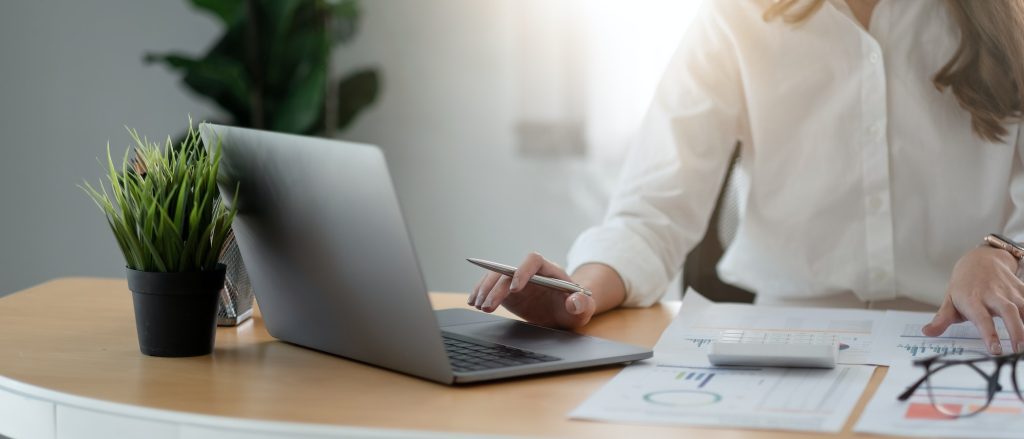 Businesswoman using calculator and laptop computer for analysis maketing plan, Accountant calculate